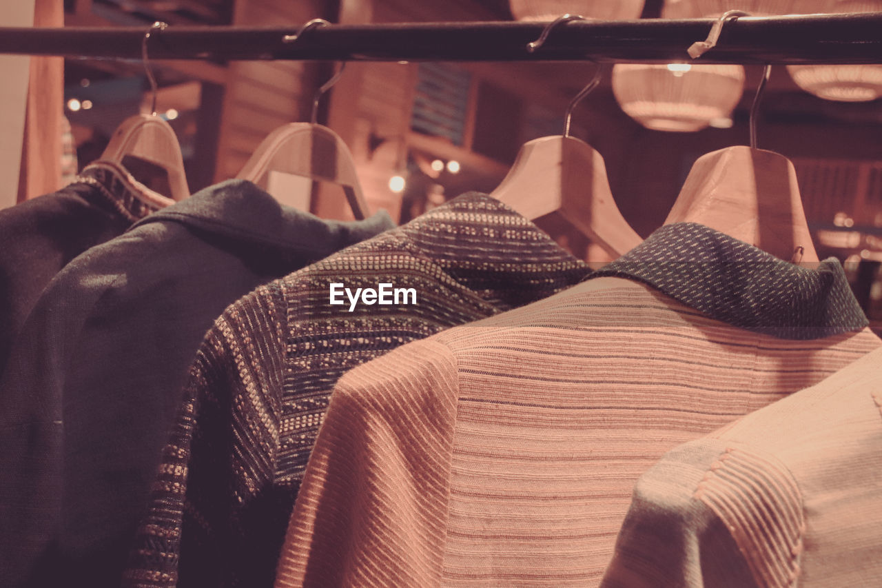 Close up of clothes hanging in shopping mall rack