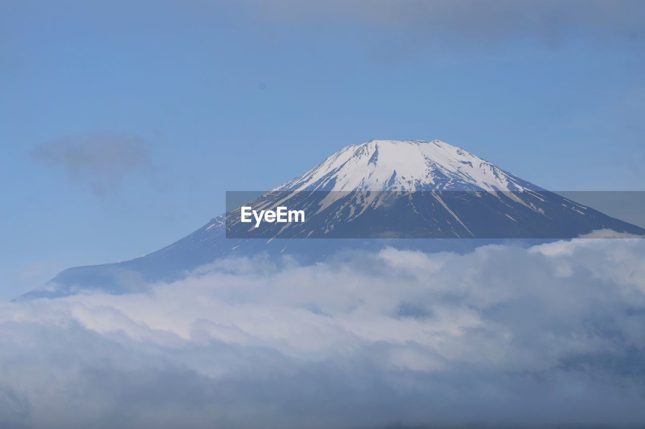 mountain, volcano, stratovolcano, sky, snow, beauty in nature, scenics - nature, snowcapped mountain, cold temperature, mountain peak, winter, nature, landscape, environment, cloud, no people, travel destinations, culture, cinder cone, outdoors, travel, land, tranquility, mountain range, blue, tranquil scene, day, non-urban scene, geology, volcanic landscape, plateau, fog, idyllic, tourism