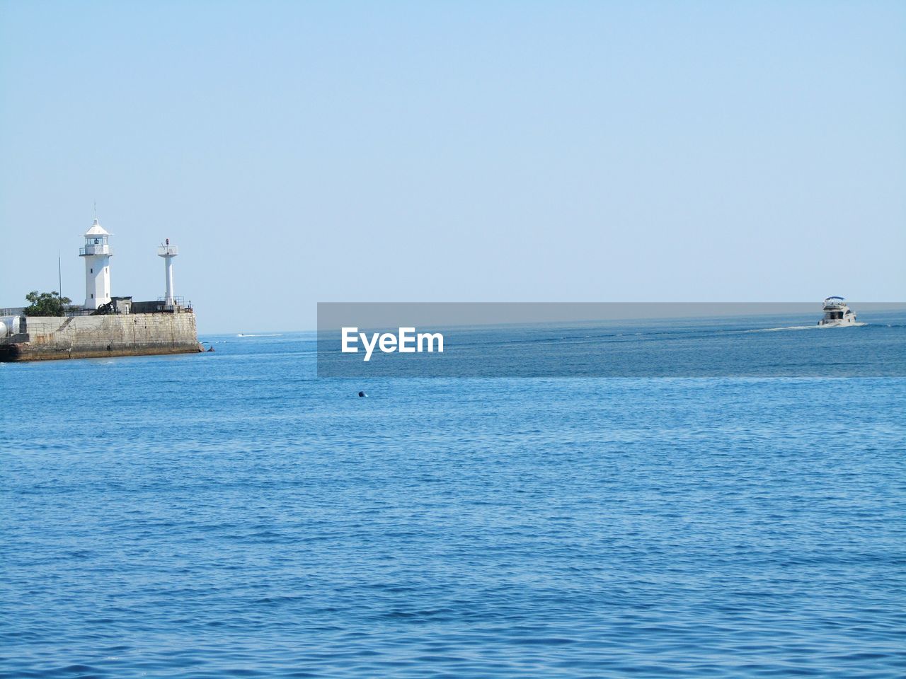 VIEW OF SHIP SAILING ON SEA AGAINST CLEAR SKY