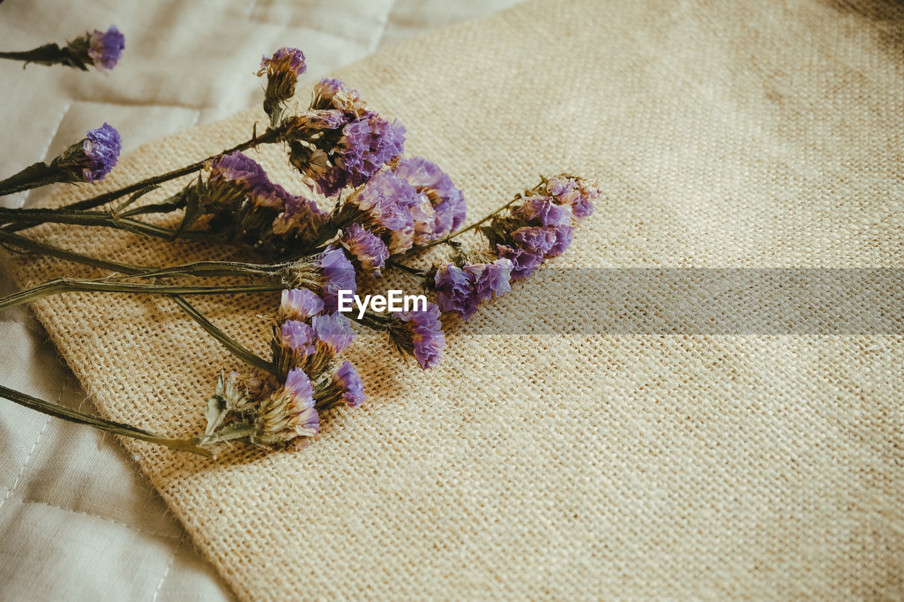 High angle view of dried flowers on burlap