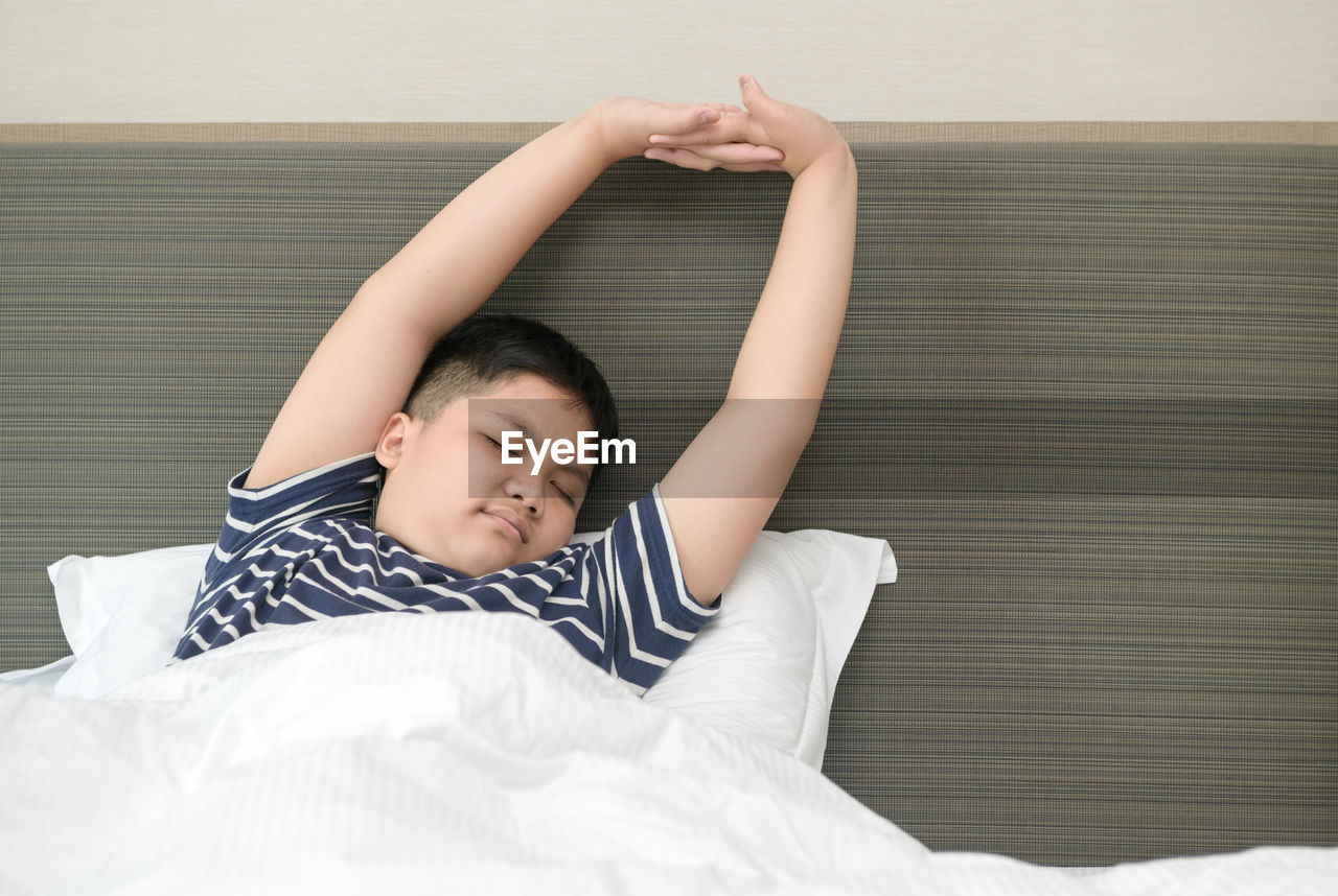 BOY RELAXING ON BED