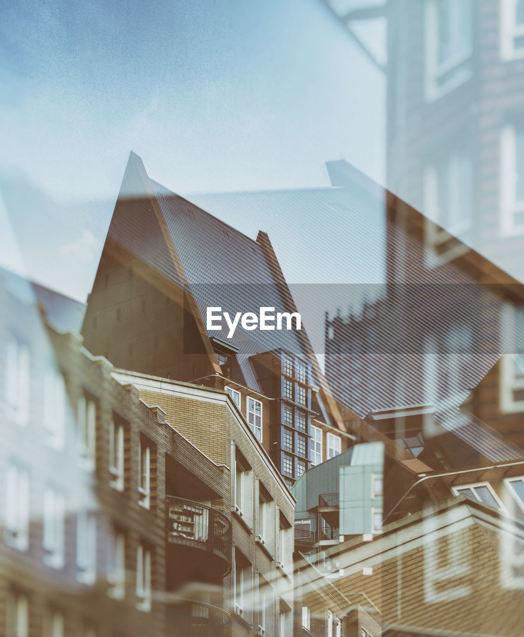 Double exposure of buildings against sky