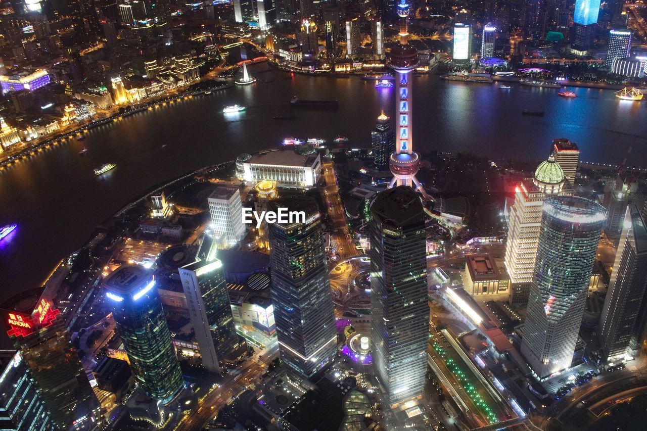 High angle view of city lit up at night