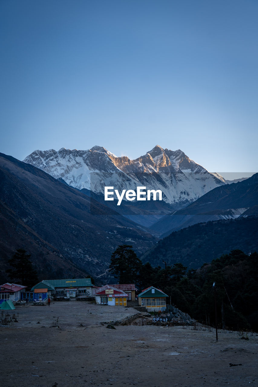 Scenic view of snowcapped mountains against clear sky