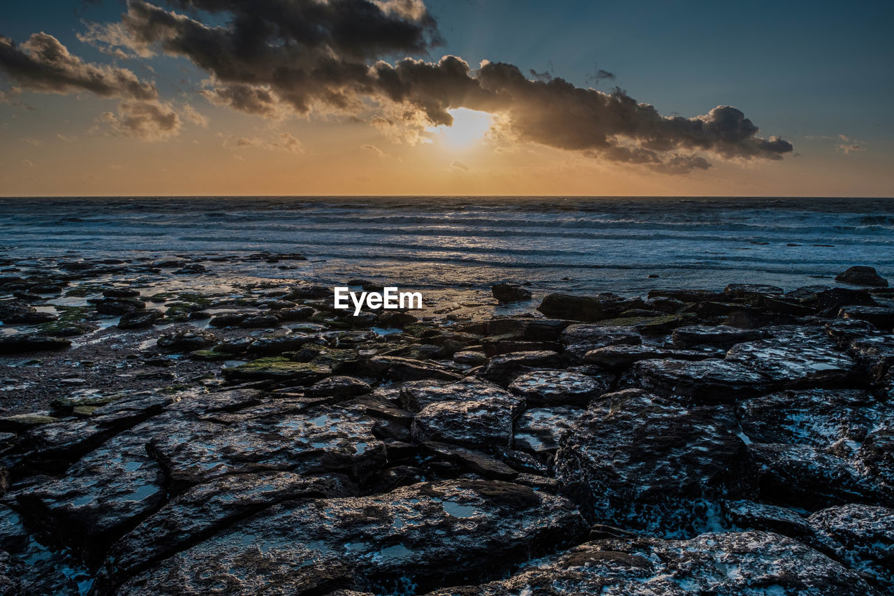 Scenic view of sea against sky during sunset