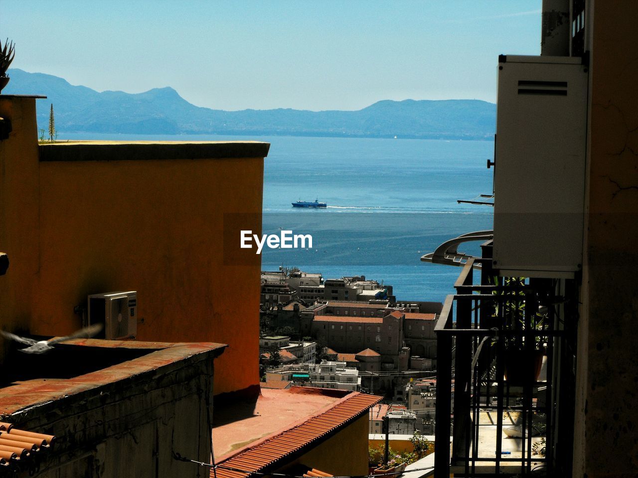 Townscape by sea against sky