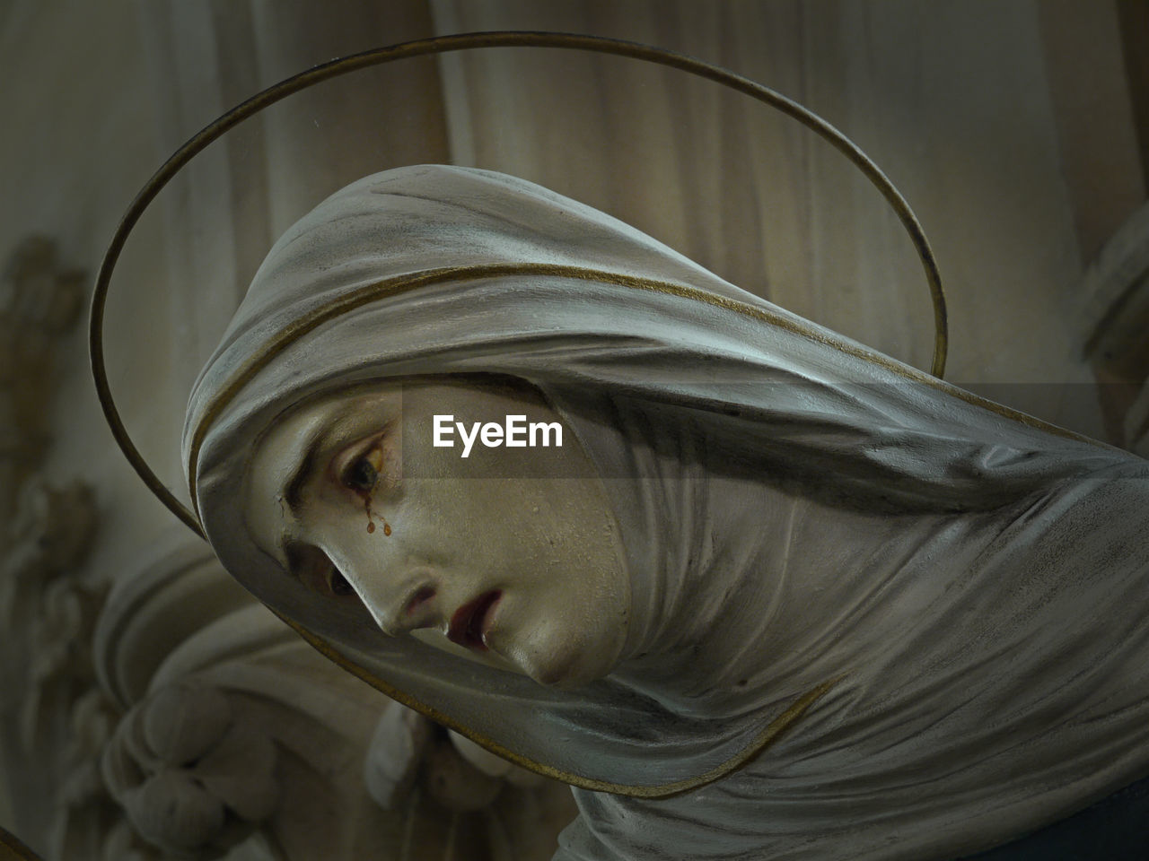 Close-up of crying virgin mary statue at church