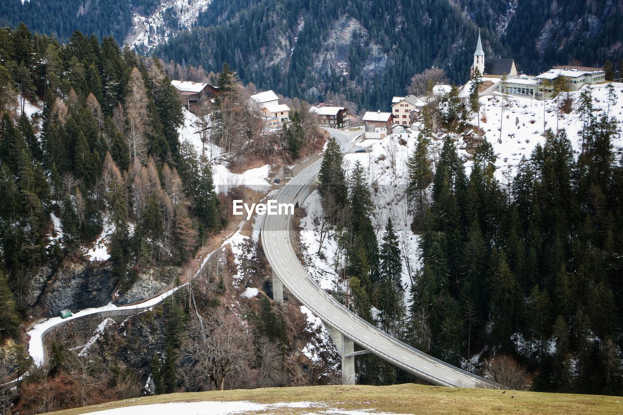 High angle view of road amidst trees during winter