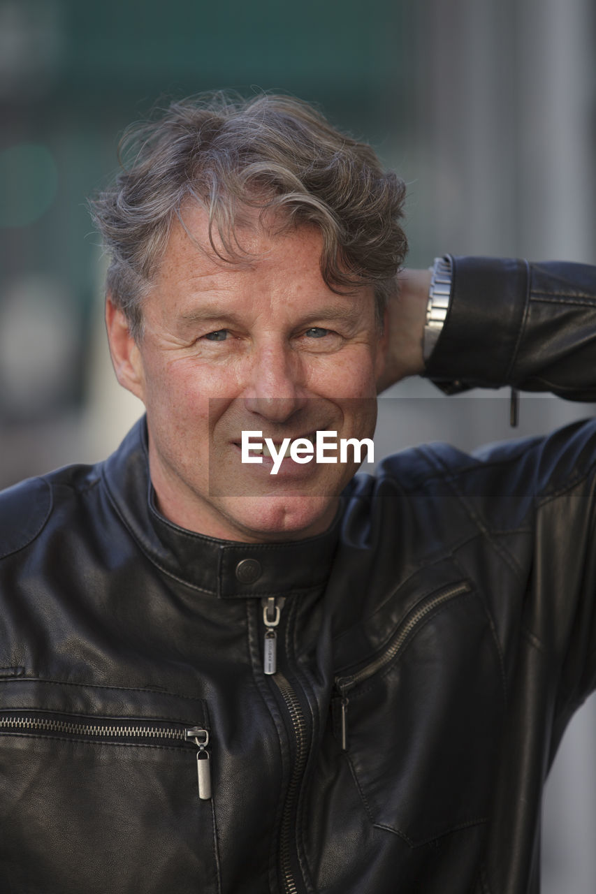 Portrait of happy man wearing black leather jacket