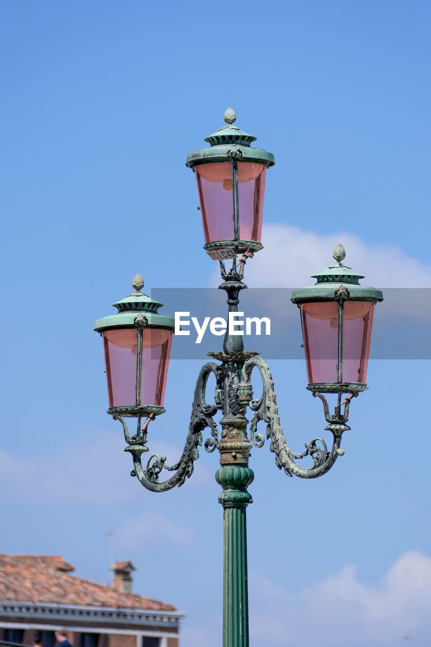 Low angle view of street light against building