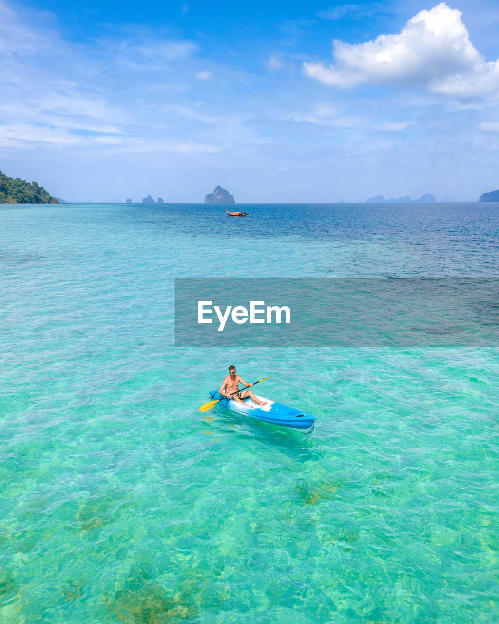 man kayaking in sea