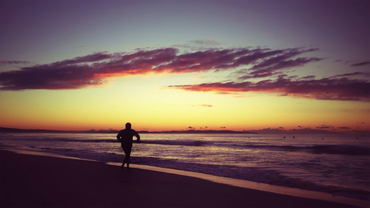 Person at shore during sunset