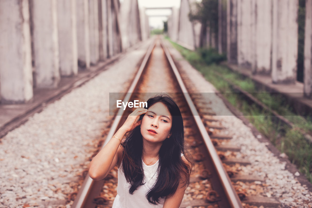 Young woman on railroad track