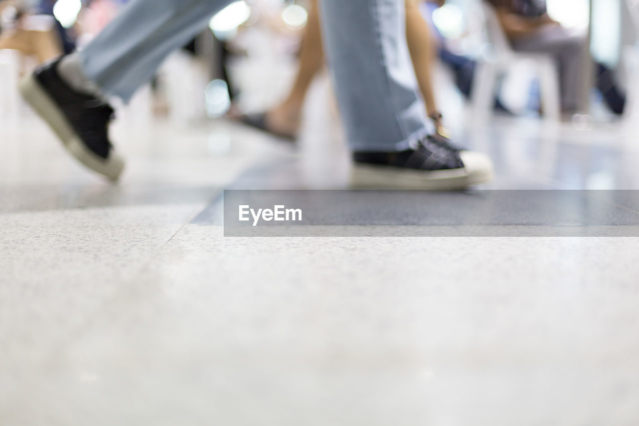 LOW SECTION OF PEOPLE WALKING ON BUS