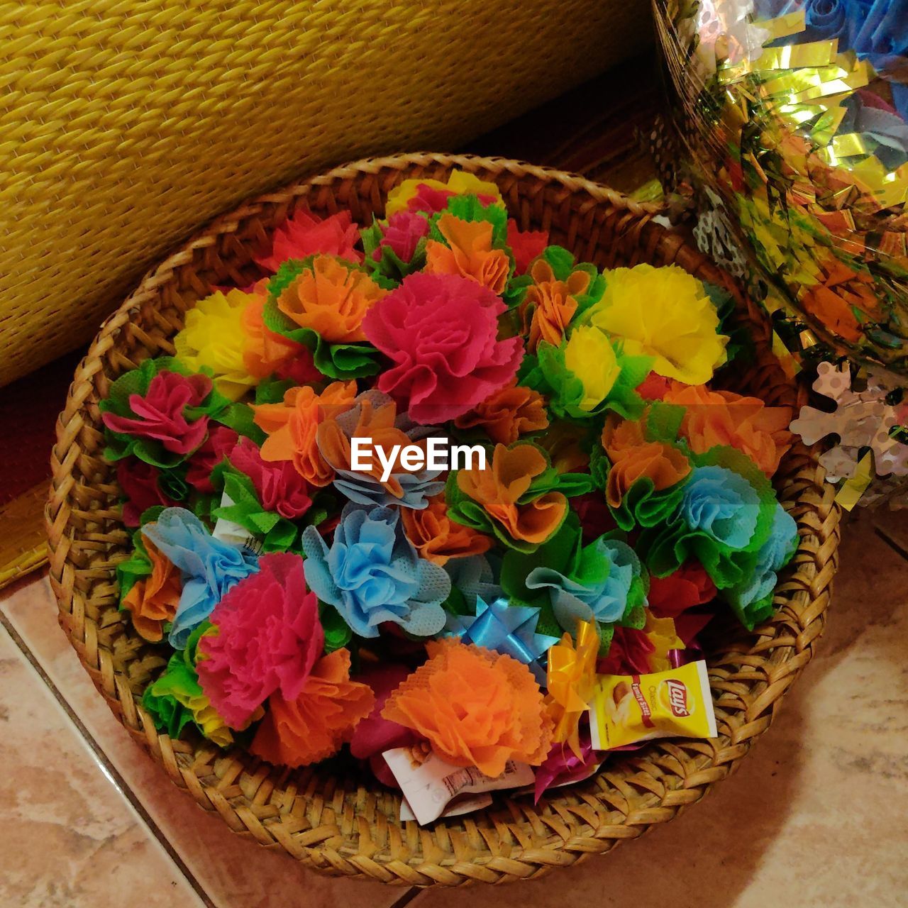 HIGH ANGLE VIEW OF MULTI COLORED FLOWER IN BASKET ON TABLE
