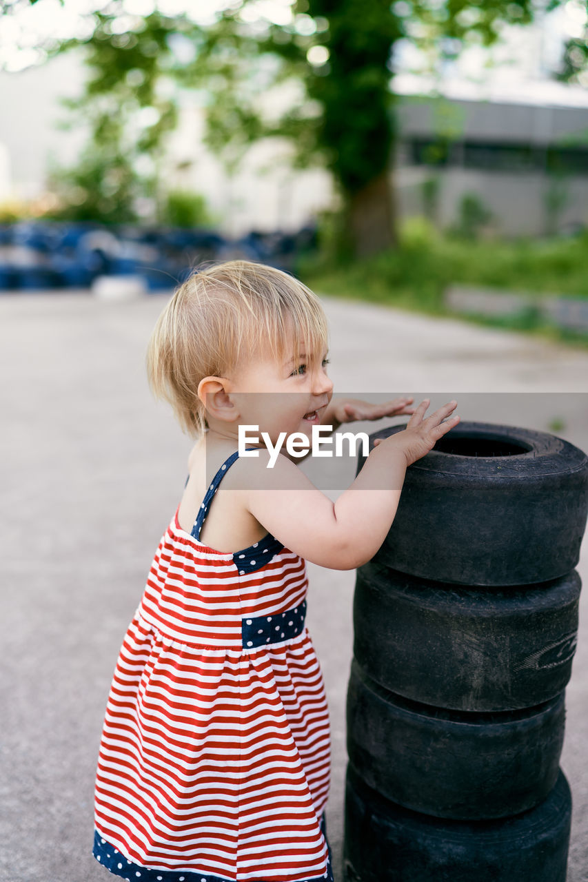 Side view of boy standing outdoors