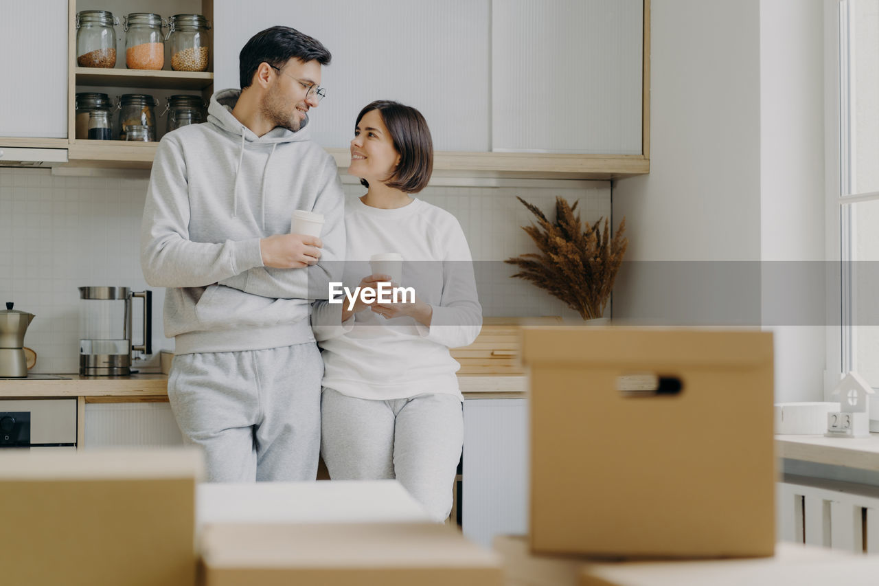 Couple standing in kitchen