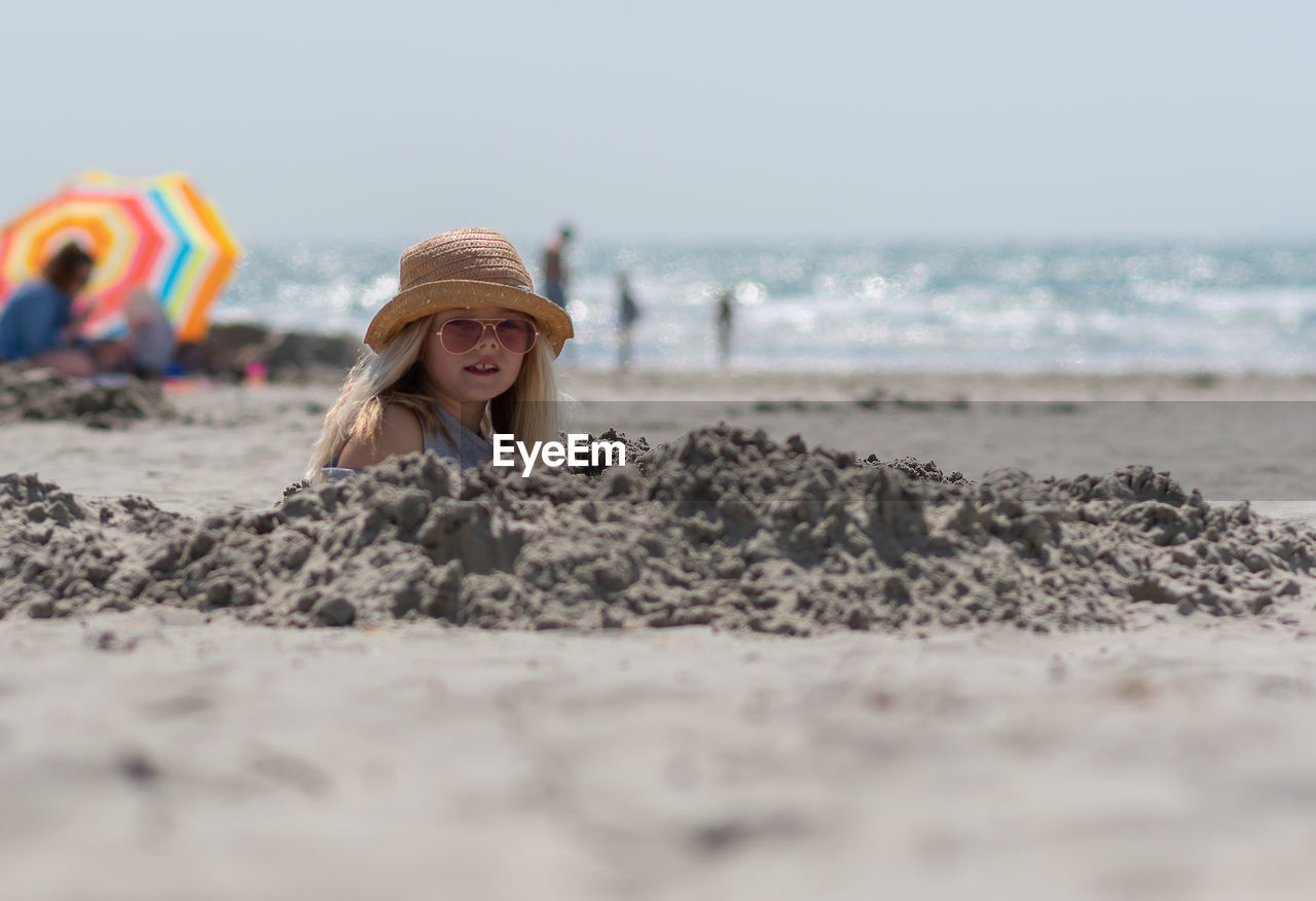 Girl buried at sandy beach
