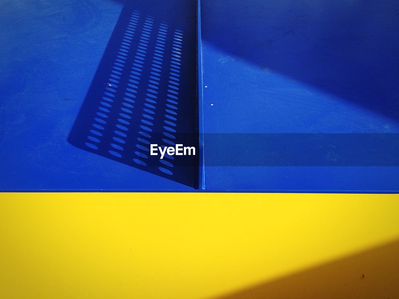 Low angle view of yellow and blue wall