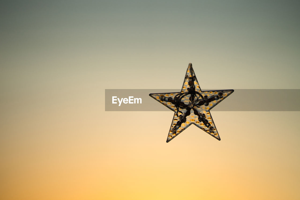 Half star on golden yellow light background.