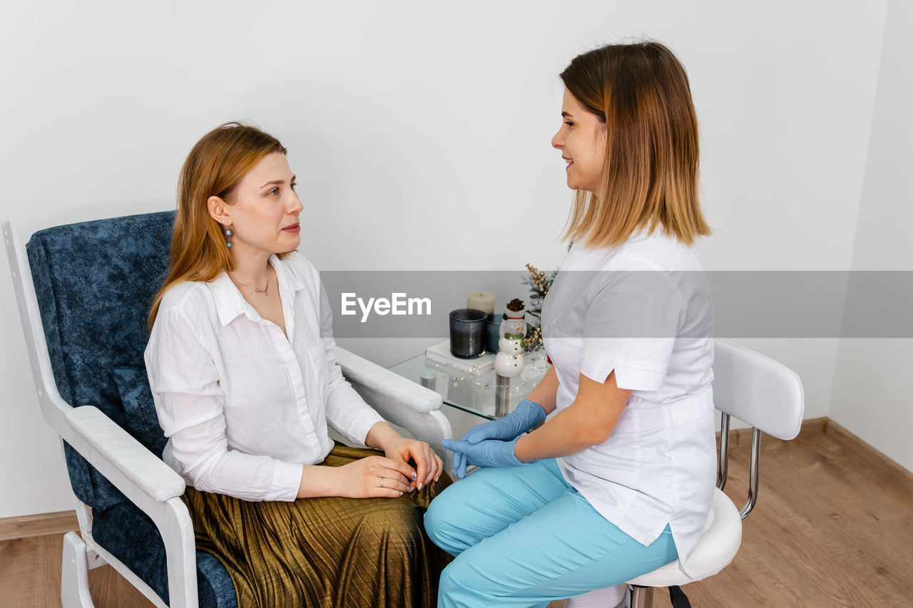 Consultation in cosmetology clinic. beautician examining face skin