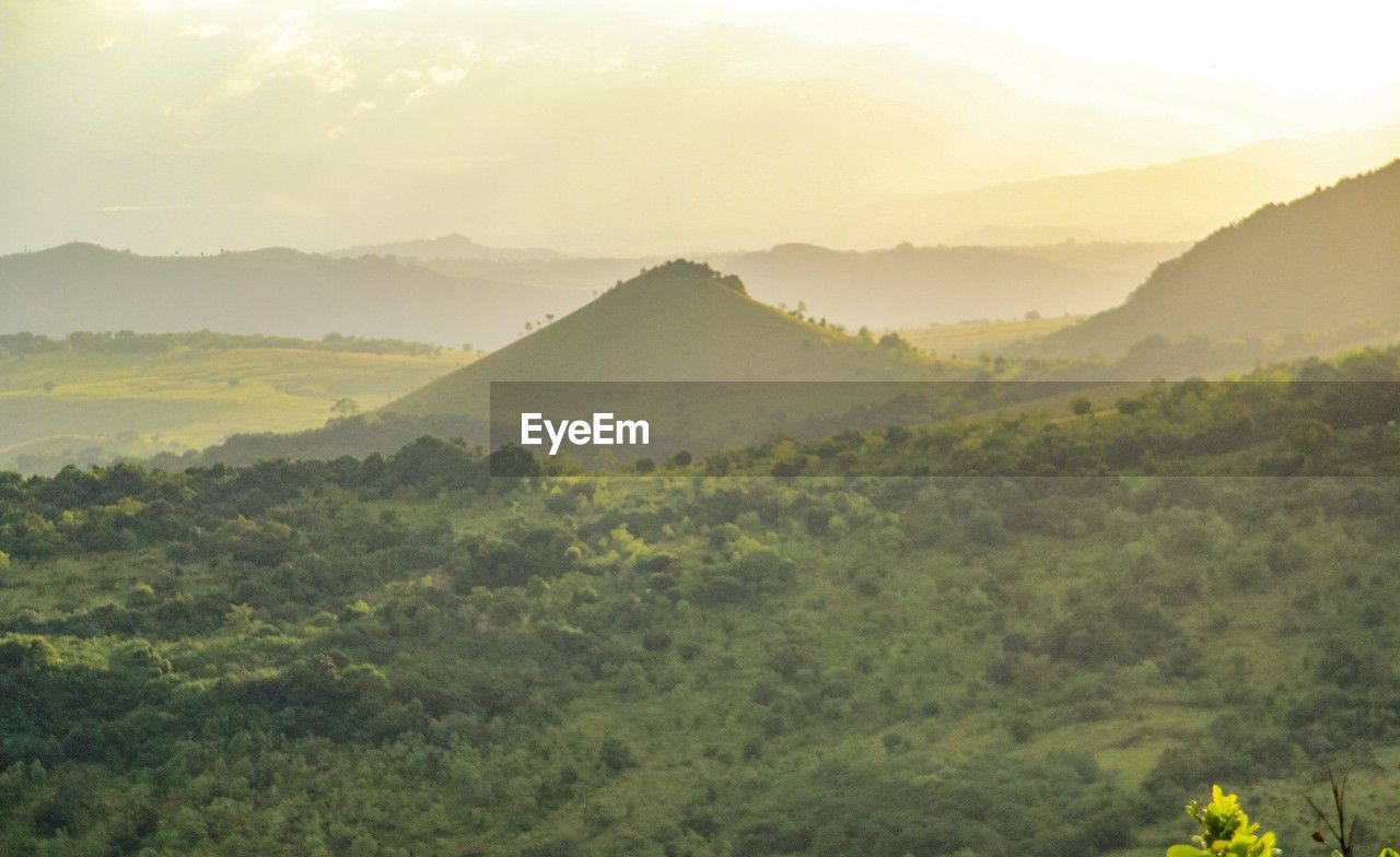 scenic view of mountains against cloudy sky