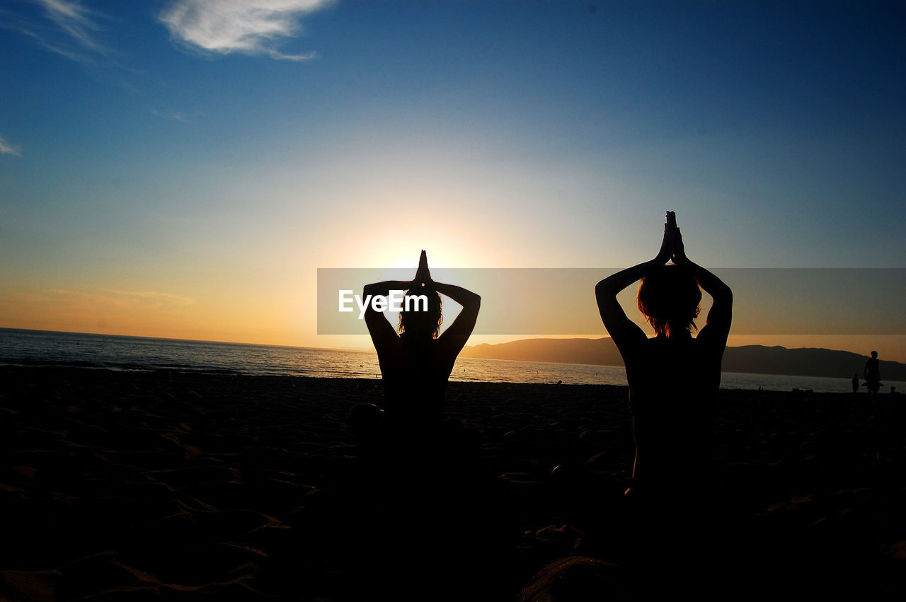 SILHOUETTE PEOPLE ON BEACH DURING SUNSET