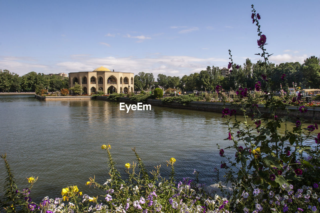 Scenic view of river against cloudy sky