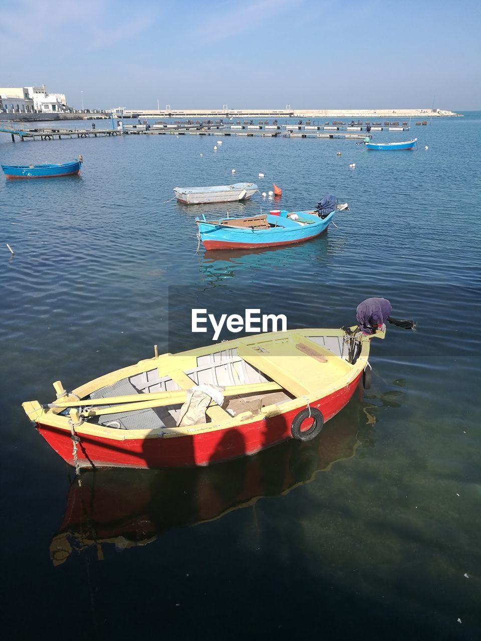 BOAT MOORED IN SEA AGAINST SKY