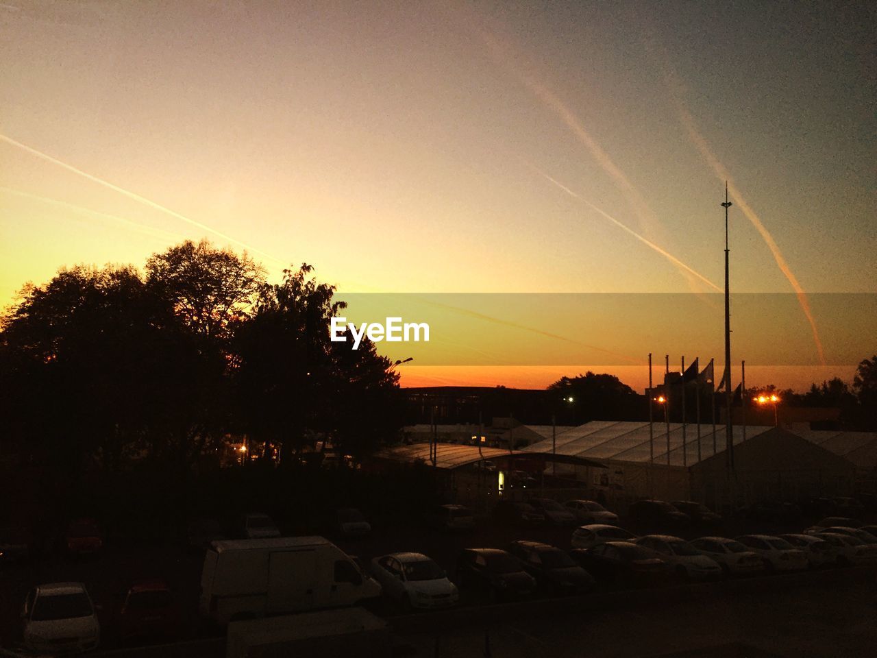 High angle view of car parking lot during sunset