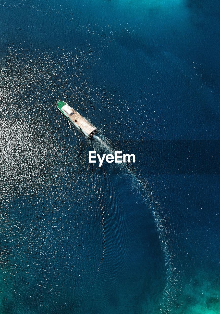 High angle view of sea against blue sky