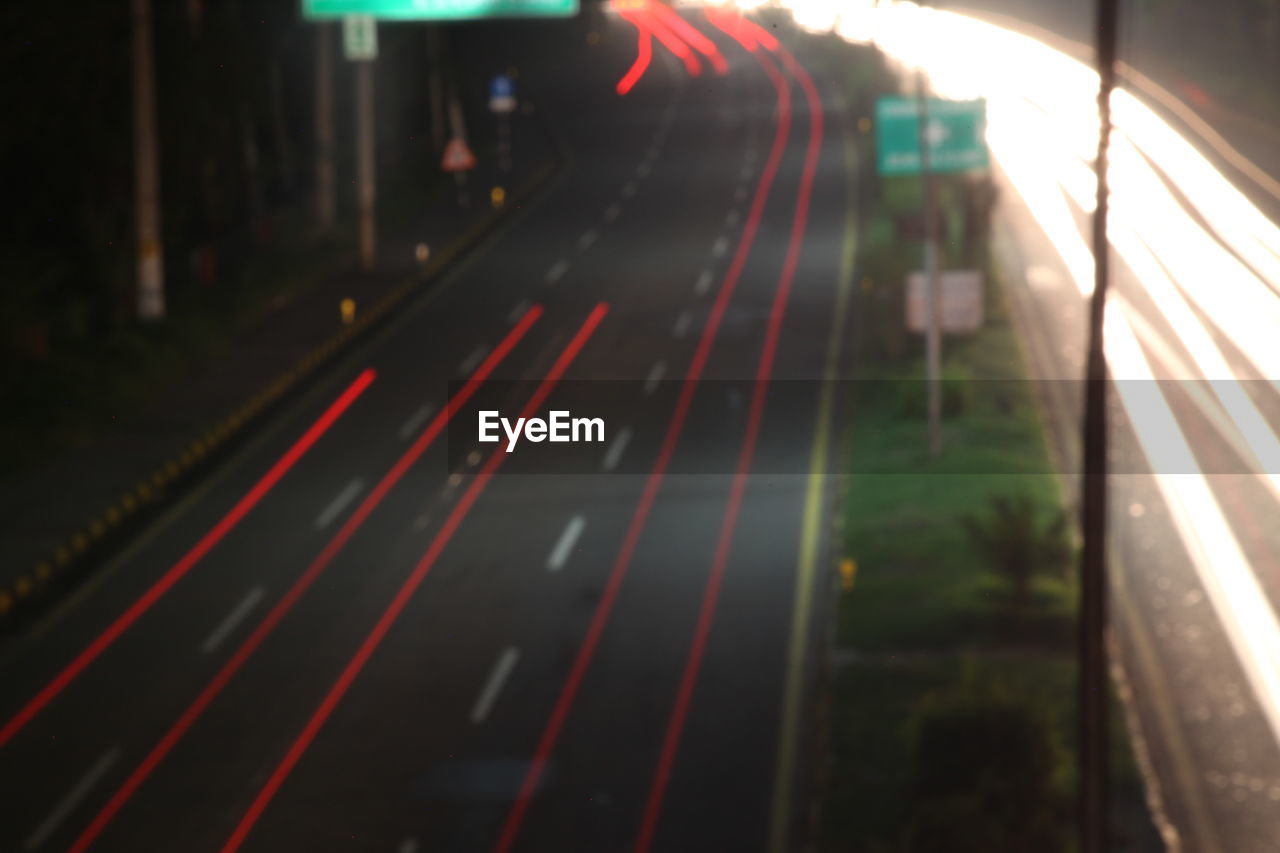 LIGHT TRAILS ON ROAD AT NIGHT