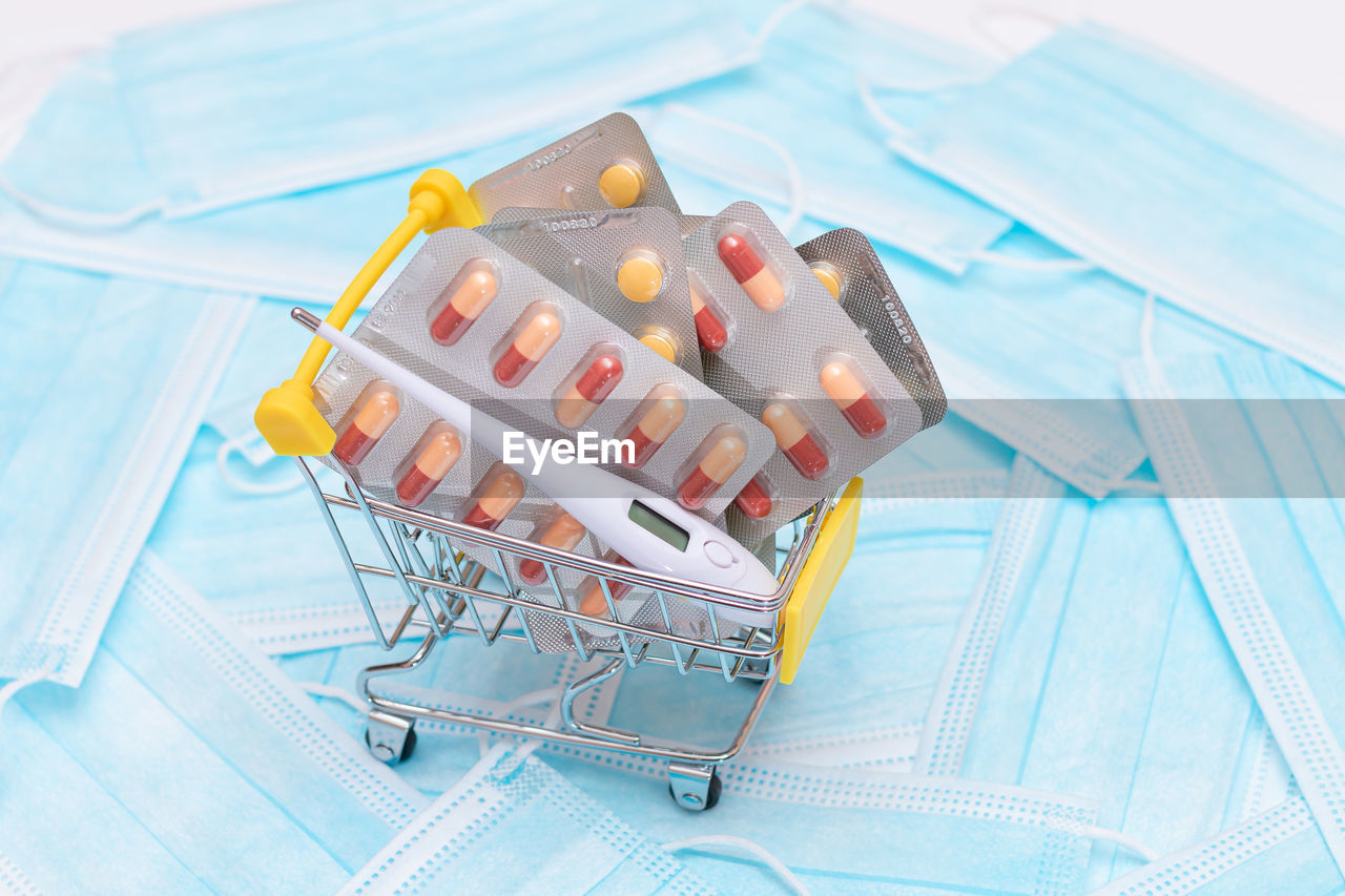 healthcare and medicine, no people, blue, indoors, studio shot, medicine, food and drink, shopping cart, food, high angle view
