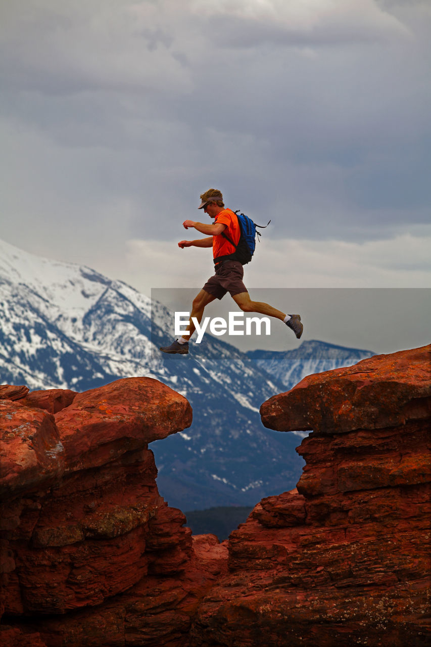 Man jumping between rocks in carbondale / colorado