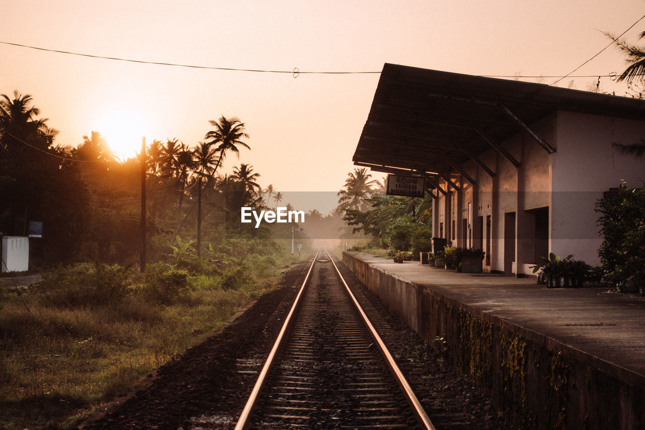 View of railroad tracks against sky during sunrise