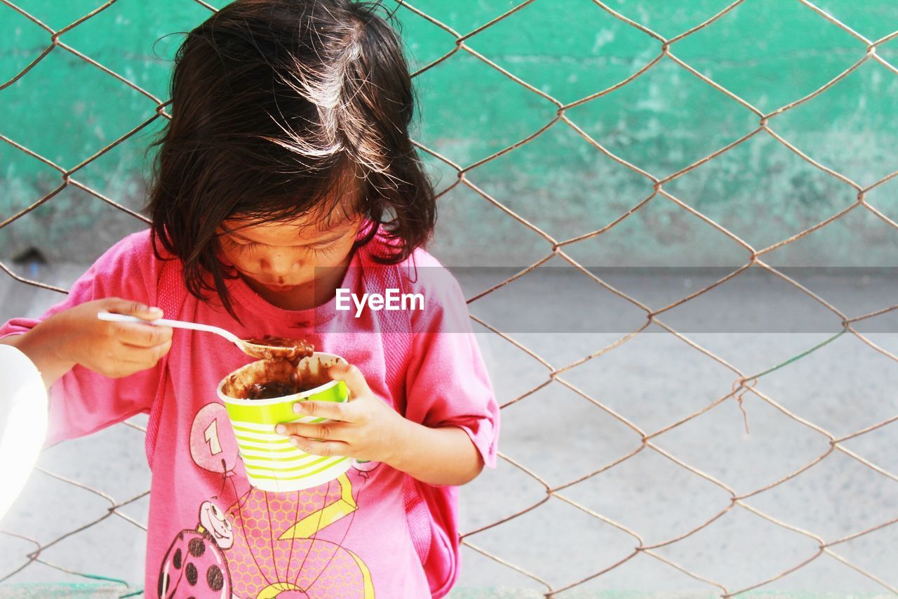 PORTRAIT OF GIRL HOLDING TOY