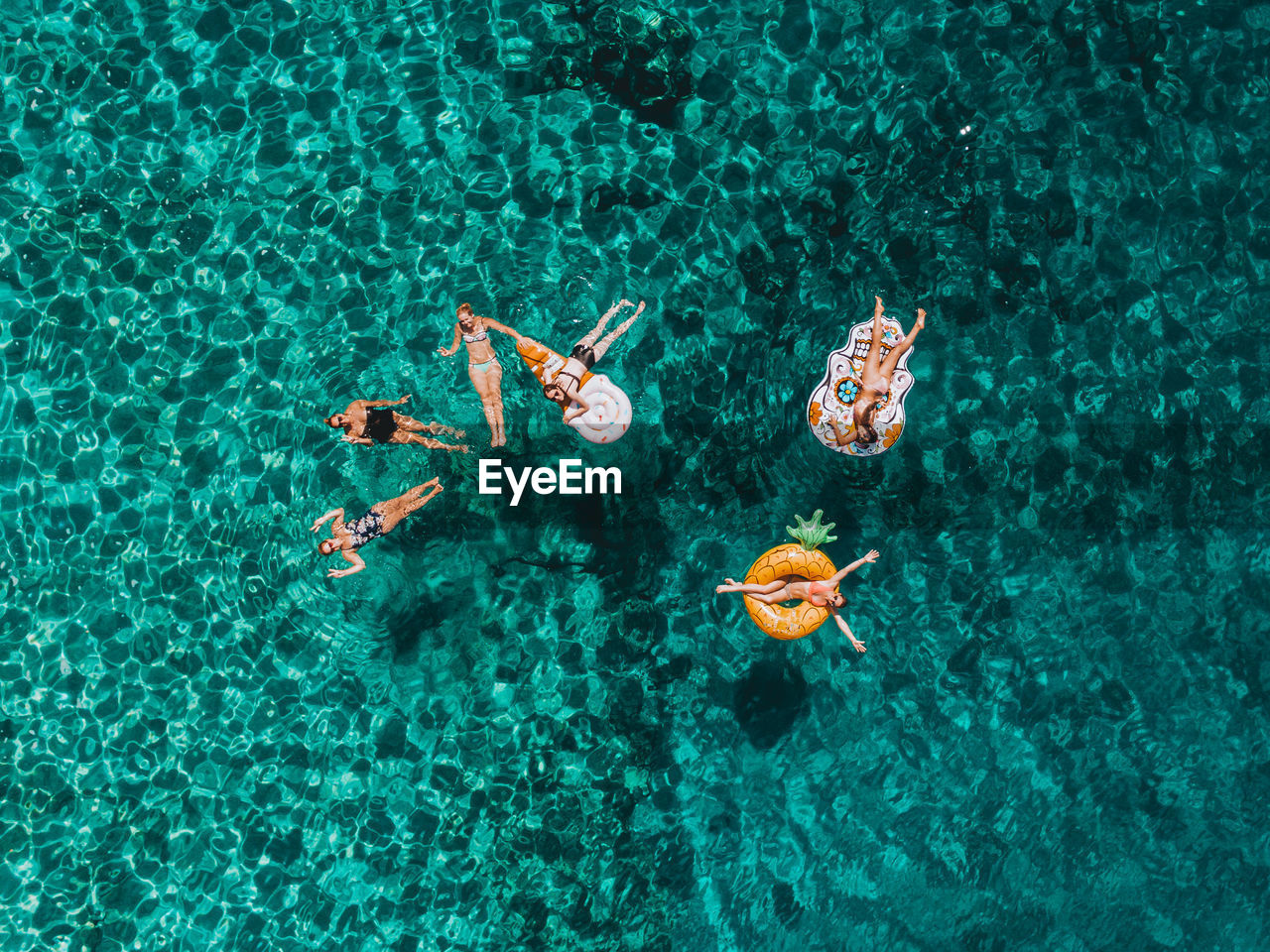 HIGH ANGLE VIEW OF PEOPLE SWIMMING UNDERWATER