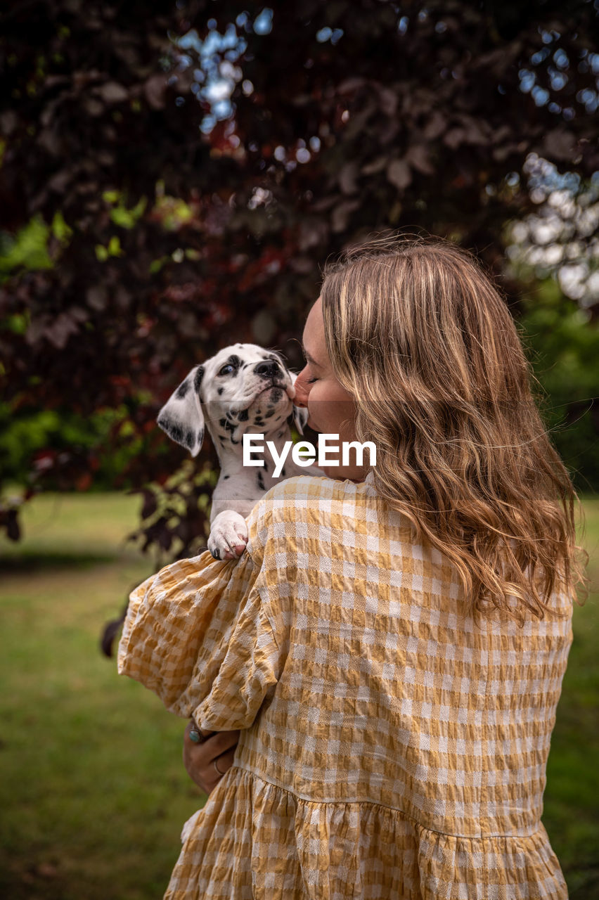 Young woman with a dalmatian puppy