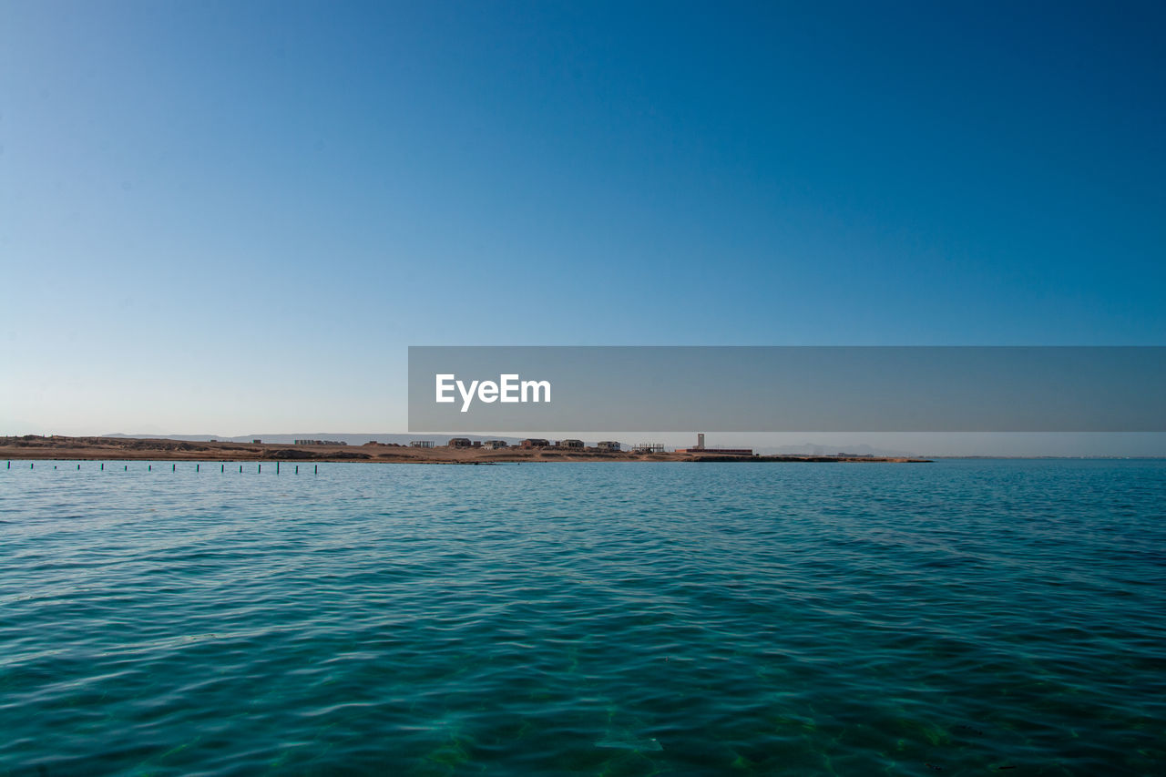 SCENIC VIEW OF BLUE SEA AGAINST CLEAR SKY