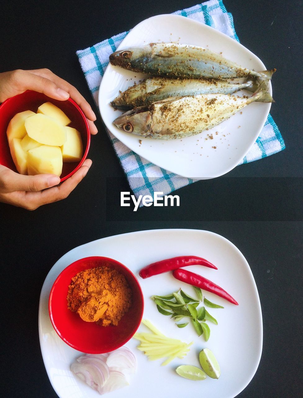 Cropped hands of person serving food on table