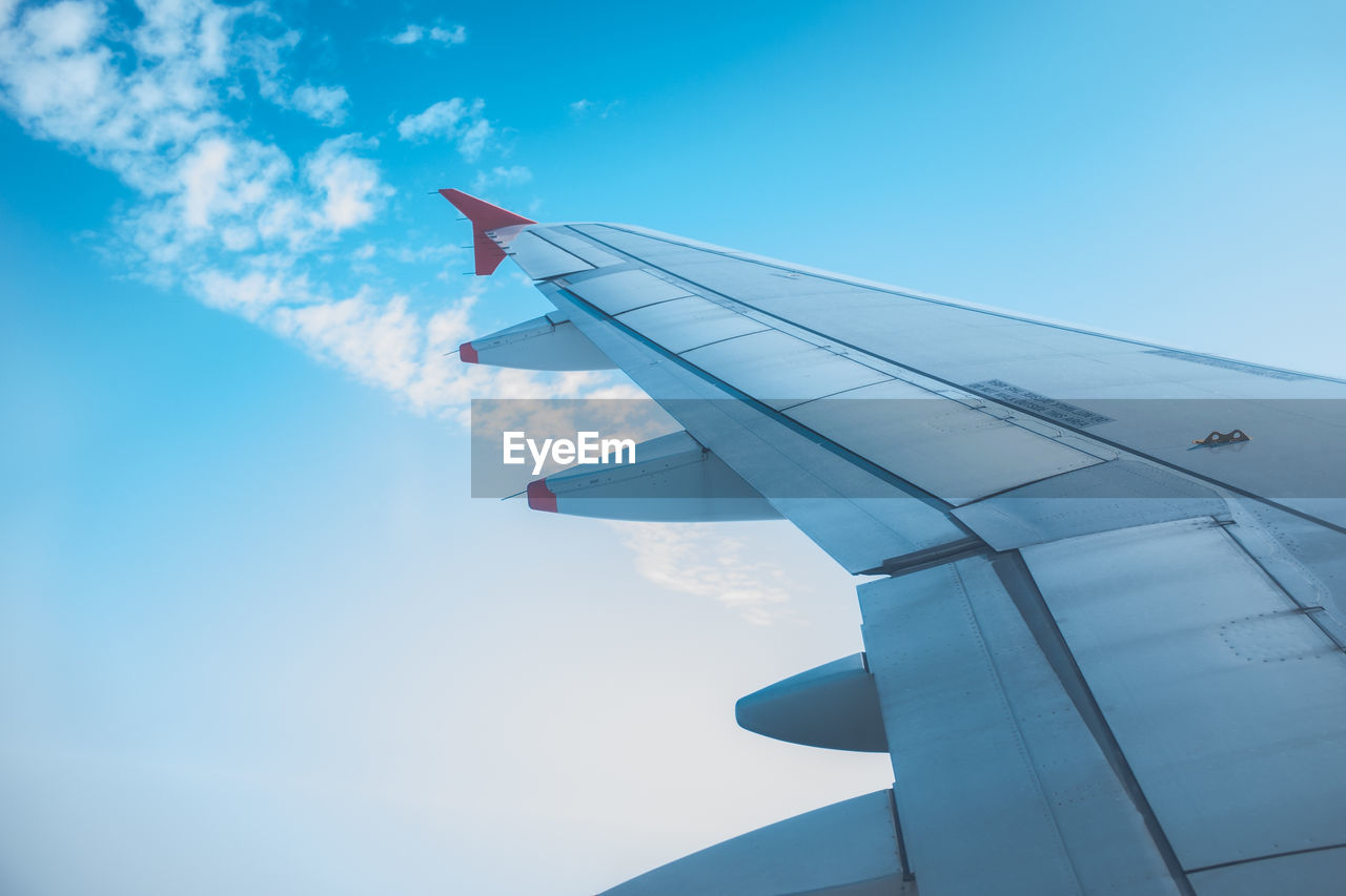 AIRPLANE FLYING OVER CLOUDS