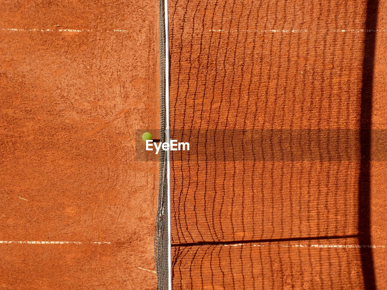 High angle view of net and ball on tennis court