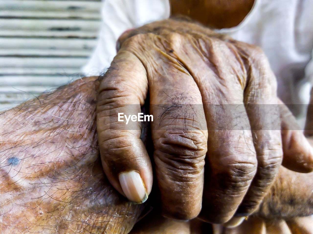 Midsection of senior men holding hands