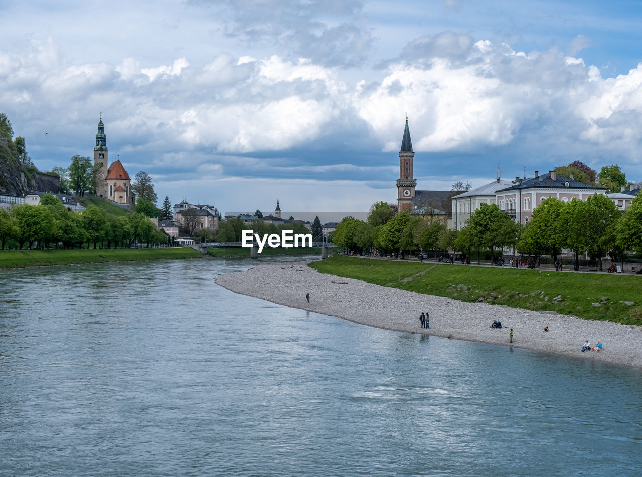 Scenic view of river and evangelical parish salzburg christ church in the distance