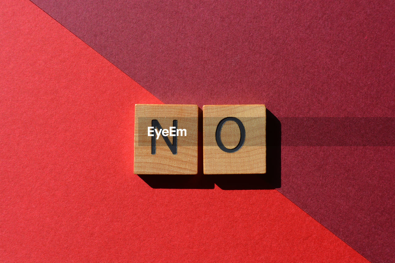 No, word in wooden alphabet letters isolated on red background