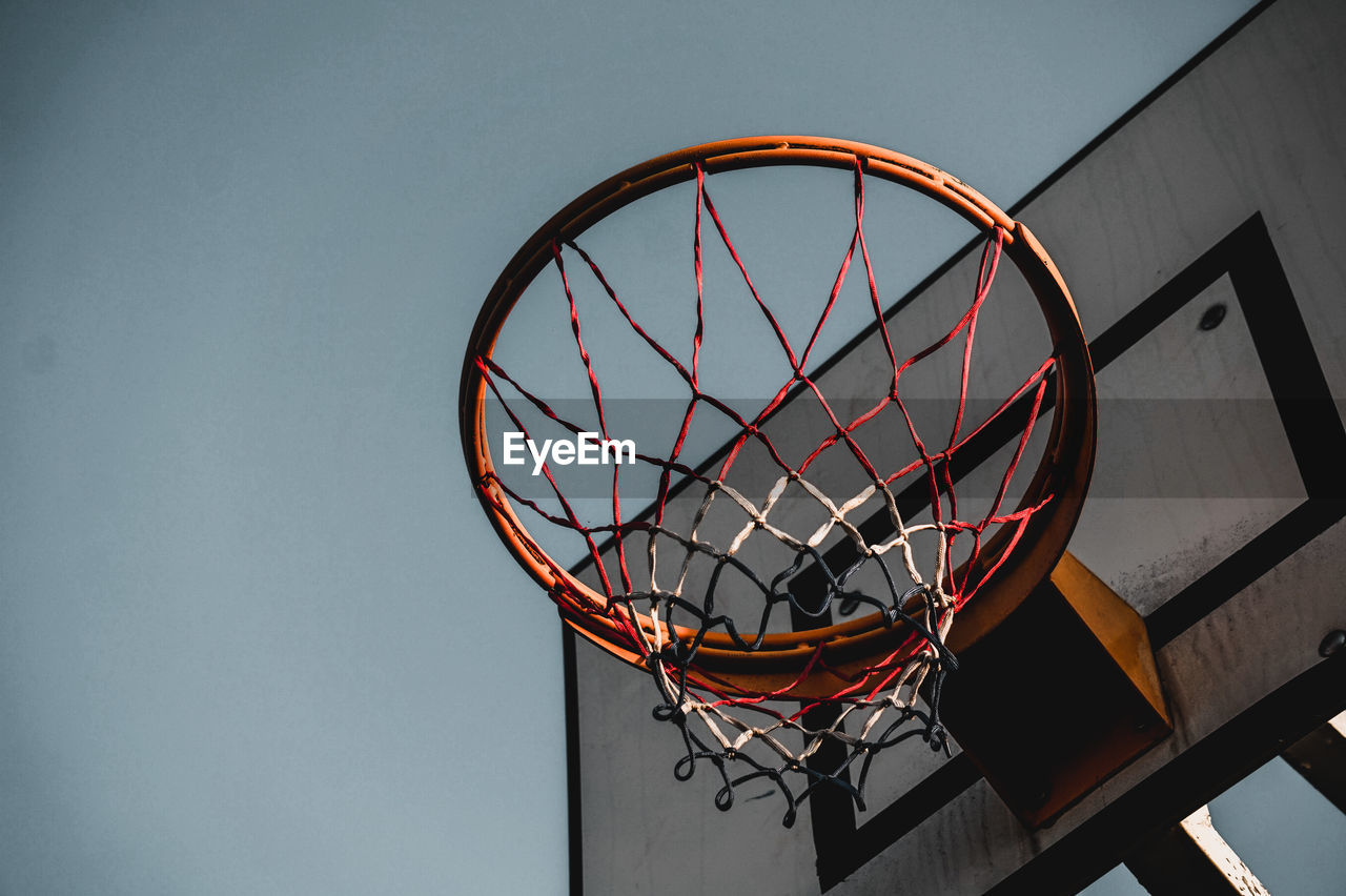 LOW ANGLE VIEW OF BASKETBALL HOOP