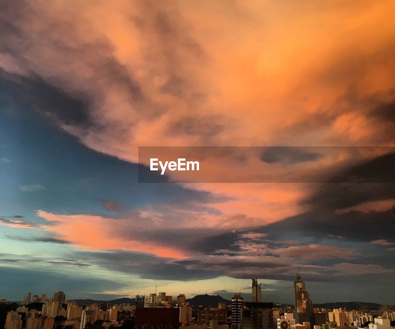 Low angle view of buildings against dramatic sky