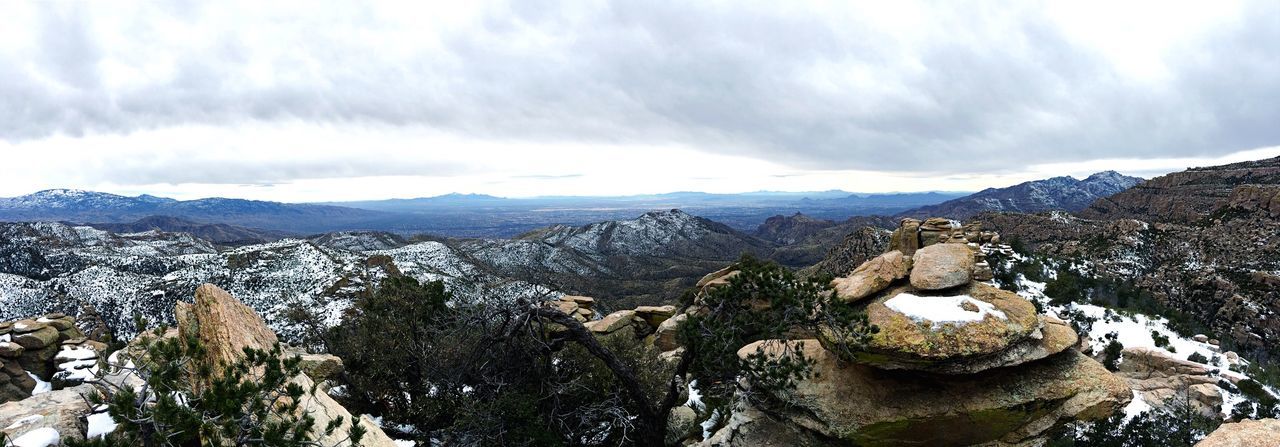 Panoramic view of mountains against cloudy sky