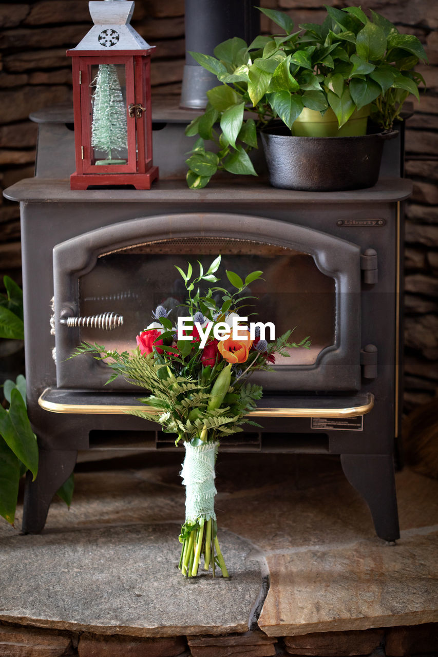 Wedding bouquet in front of antique heater. rustic wedding bridal florals