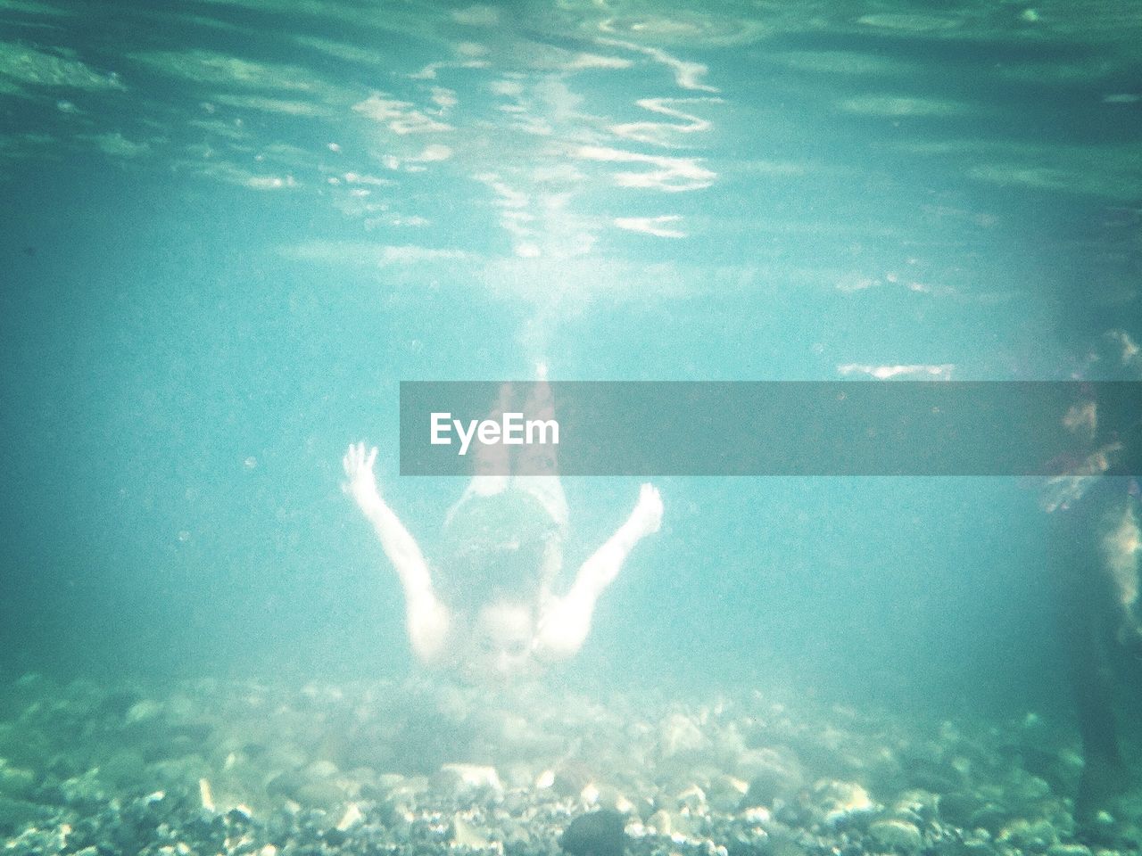 Woman swimming undersea in cirali beach